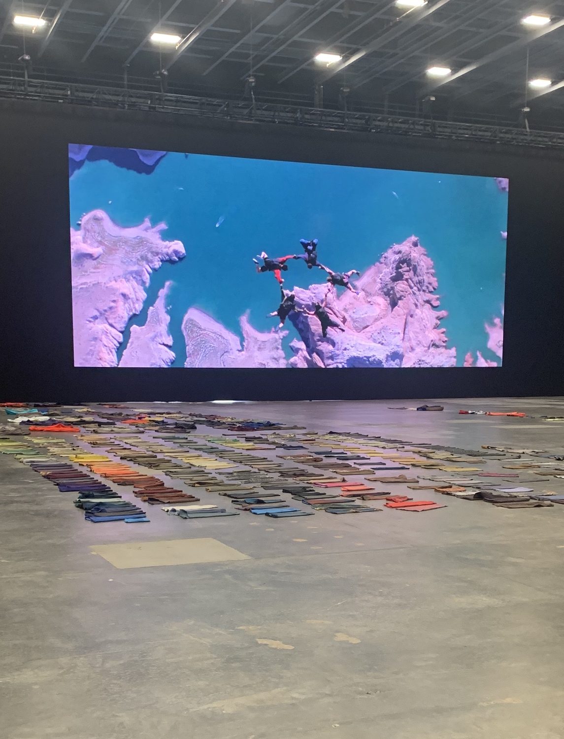 The full Yeezy collection laid out in a color-graded grid beneath a monumental screen